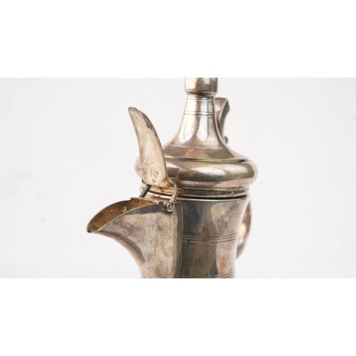 48 - A SILVER ARABIC COFFEE POT, MIDDLE EAST, OMAN Of traditional shape, a silver coffee pot with a long ... 