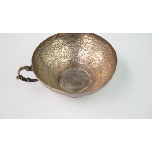 6 - A FINELY ENGRAVED SILVER CUP The interior profoundly engraved with a band of Arabic inscriptions, en... 