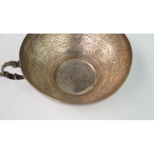 6 - A FINELY ENGRAVED SILVER CUP The interior profoundly engraved with a band of Arabic inscriptions, en... 