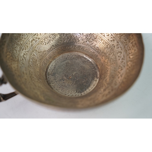 6 - A FINELY ENGRAVED SILVER CUP The interior profoundly engraved with a band of Arabic inscriptions, en... 