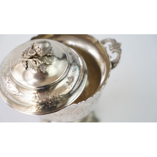 9 - A SILVER SUGAR BOWL WITH A LID Of circular form raised upon bracket feet, handles at both sides, the... 