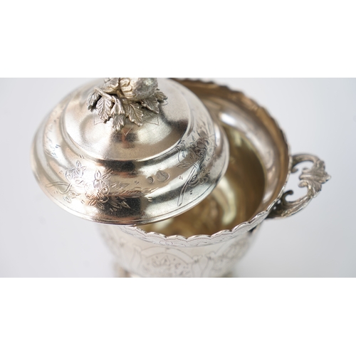 9 - A SILVER SUGAR BOWL WITH A LID Of circular form raised upon bracket feet, handles at both sides, the... 