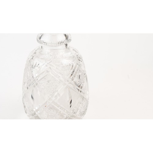 140 - AN ELEGANT CRYSTAL DECANTER AND ITS STOPPER,The decanter of rounded form, the faceted face accented ... 