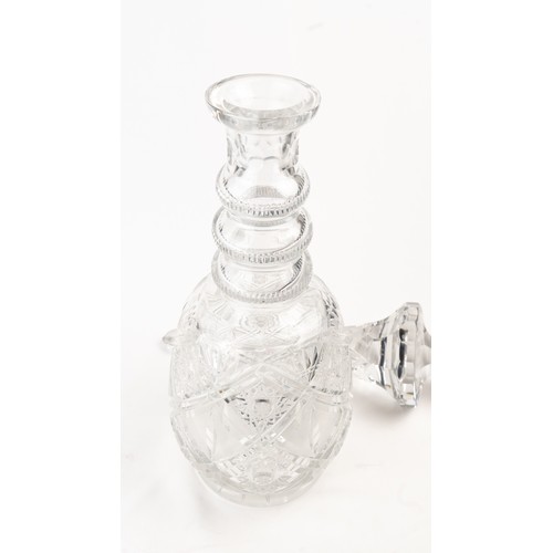 140 - AN ELEGANT CRYSTAL DECANTER AND ITS STOPPER,The decanter of rounded form, the faceted face accented ... 