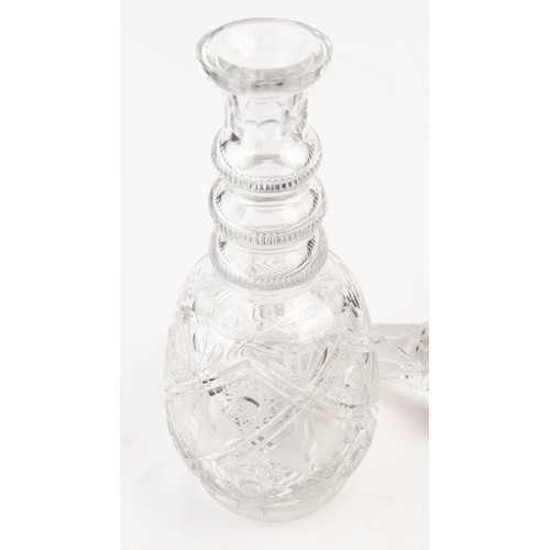 140 - AN ELEGANT CRYSTAL DECANTER AND ITS STOPPER,The decanter of rounded form, the faceted face accented ... 