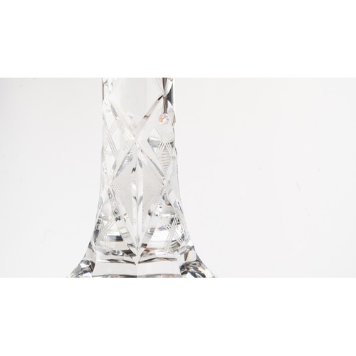 140 - AN ELEGANT CRYSTAL DECANTER AND ITS STOPPER,The decanter of rounded form, the faceted face accented ... 