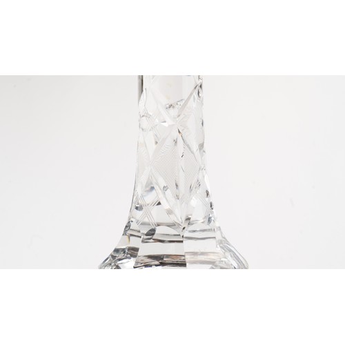 140 - AN ELEGANT CRYSTAL DECANTER AND ITS STOPPER,The decanter of rounded form, the faceted face accented ... 