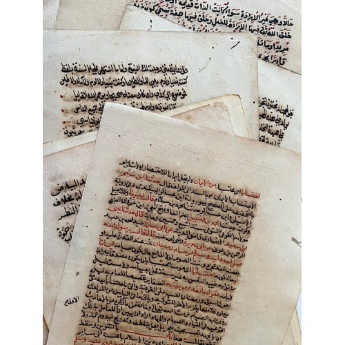 136 - A SET OF ELEVEN SIMILAR ISLAMIC FOLIOS 
NORTH AFRICA
Arabic manuscript on paper,sepia naskh script o... 