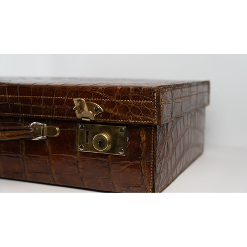 2 - A FINE CROCODILE LEATHER TRAVEL CASE.Of rectangular form, a travel case featuring a rich crocodile s... 