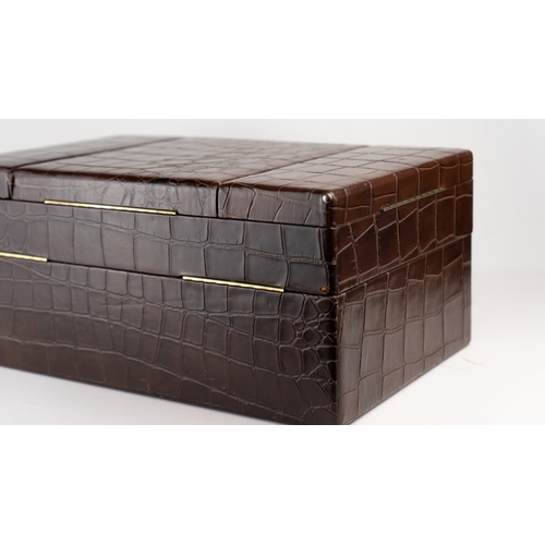 6 - A CROCODILE LEATHER TRAVEL AND VANITY CASE,              
Of rectangular form, formed of two layers,... 