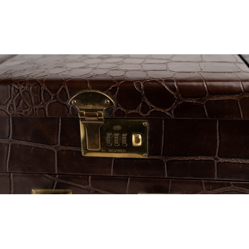 6 - A CROCODILE LEATHER TRAVEL AND VANITY CASE,              
Of rectangular form, formed of two layers,... 