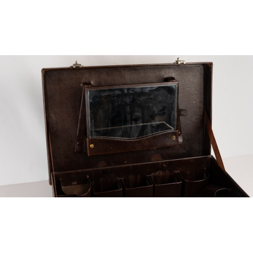 7 - A DARK BROWN LEATHER CASEOf rectangular form, the exterior featuring leather in dark brown hues, int... 