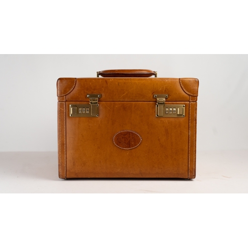 17 - A LEATHER TRAVEL BAG, INTERCHASSE, PARIS, 
Of cubic form, a travel bag equipped with a 3-dial combin... 