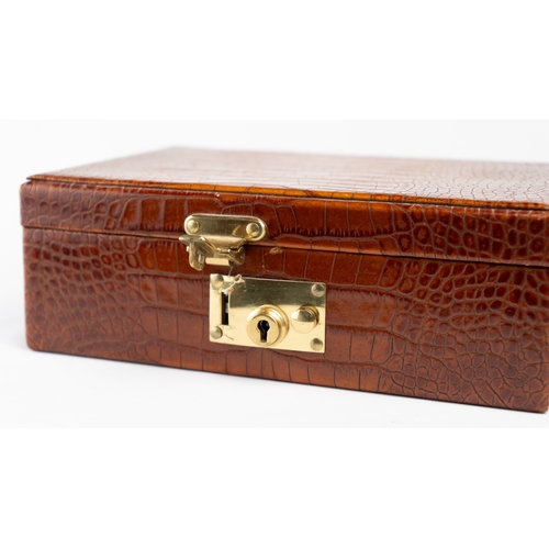 21 - A CROCODILE LEATHER JEWELLERY BOX.        Of rectangular form, exterior crocodile leather, velvet-li... 