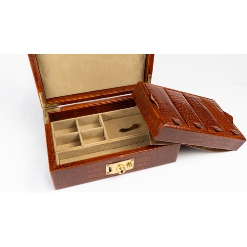 21 - A CROCODILE LEATHER JEWELLERY BOX.        Of rectangular form, exterior crocodile leather, velvet-li... 