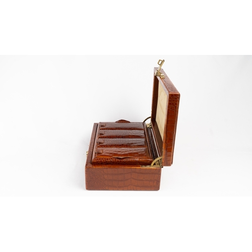 21 - A CROCODILE LEATHER JEWELLERY BOX.        Of rectangular form, exterior crocodile leather, velvet-li... 