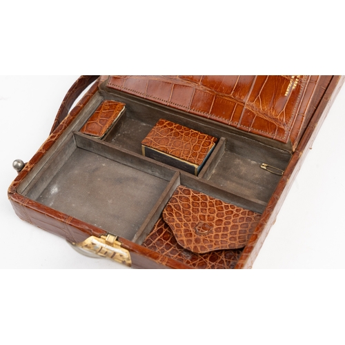 25 - BROWN CROCODILE TRAVEL HAND BAG, FORTNUM&MASON, LONDON
Of rectangular form, a brown crocodile leathe... 