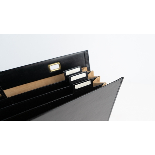 43 - A BLACK LEATHER DOCUMENT HOLDER,
Of rectangular form, the front pocket, the interior housing four se... 