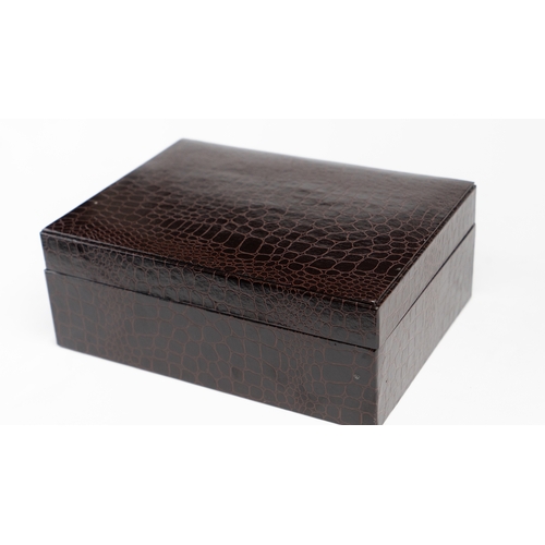 52 - A LEATHER HUMIDOR

Of rectangular form, interior velvety lining, opening to reveal hygrometer and th... 