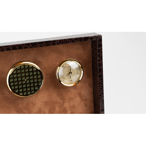 52 - A LEATHER HUMIDOR

Of rectangular form, interior velvety lining, opening to reveal hygrometer and th... 