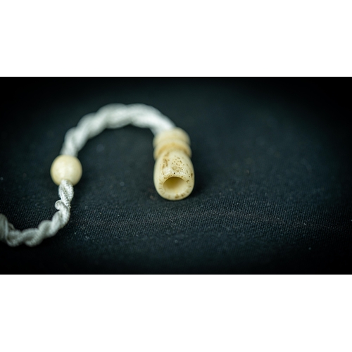 92 - A MORS TOOTH PRAYER BEADS

The tasbih strung  with 99 bone spherical  beads, flat stops, narrowing a... 