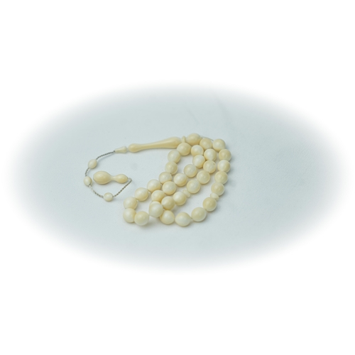 95 - A BONE PRAYER BEADS

The tasbih strung with 33 bone spherical beads, flat stops, narrowing and elong... 