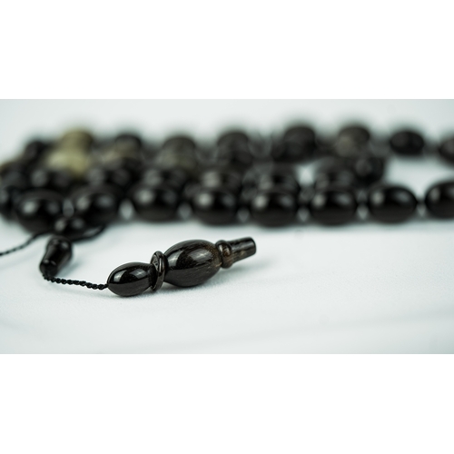 96 - RHINO HORN PRAYER BEADS
The tasbih strung  with 33  ovoid  beads, flat stops, narrowing and nicely e... 