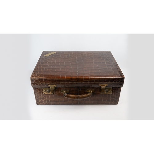 110 - AN EDWARDIAN ALLIGATOR SUITCASE,

Of rectangular shape, crafted in a crocodile-patterned leather, fe... 