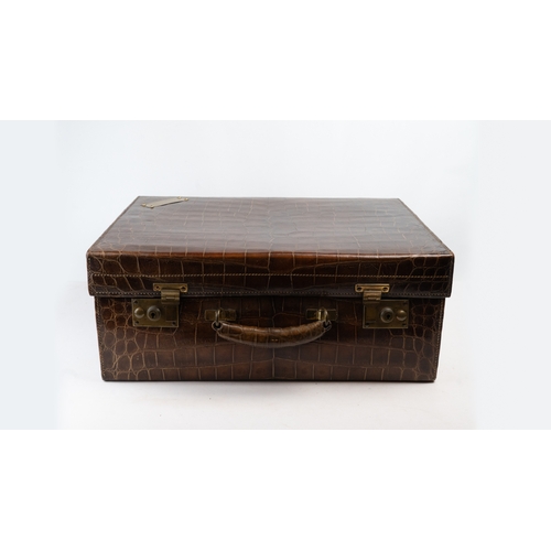 110 - AN EDWARDIAN ALLIGATOR SUITCASE,

Of rectangular shape, crafted in a crocodile-patterned leather, fe... 