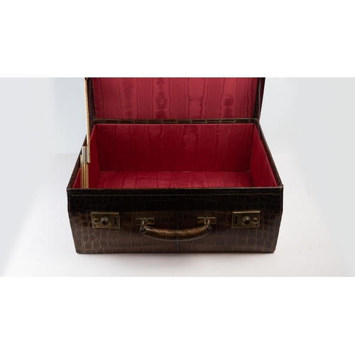 110 - AN EDWARDIAN ALLIGATOR SUITCASE,

Of rectangular shape, crafted in a crocodile-patterned leather, fe... 