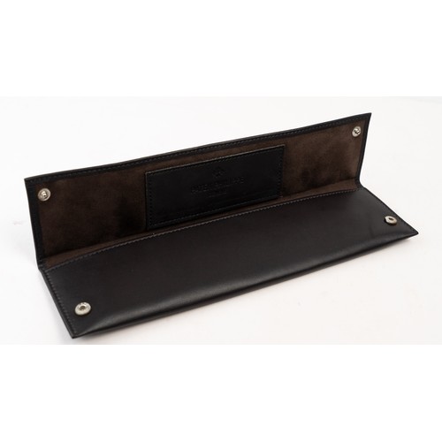 13 - A  PATEK PHILIPPE LEATHER WATCH CASE
Of rectangular form, lined with suede, crafted in dark brown le... 