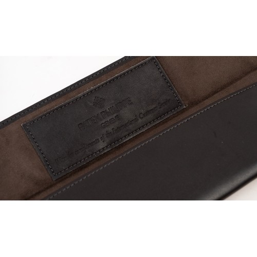 13 - A  PATEK PHILIPPE LEATHER WATCH CASE
Of rectangular form, lined with suede, crafted in dark brown le... 