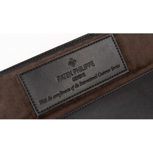 14 - A  PATEK PHILIPPE LEATHER WATCH CASE
Of rectangular form, lined with suede, crafted in dark brown le... 