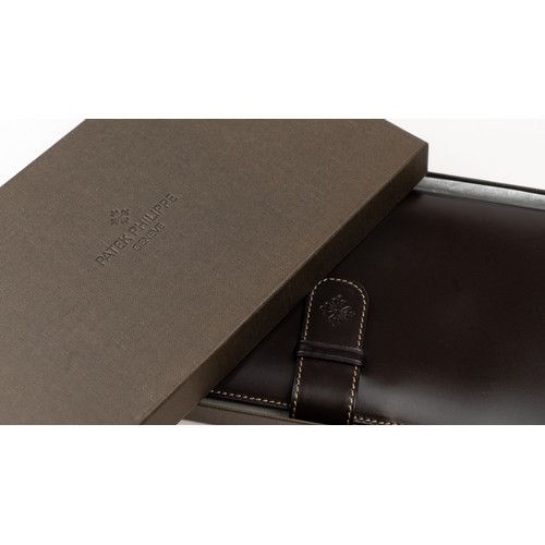 15 - BRAND-NEW DARK BROWN A PATEK PHILIPPE PASSPORT HOLDER, CENEVE
Of rectangular form, crafted in dark b... 