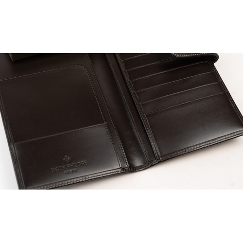 15 - BRAND-NEW DARK BROWN A PATEK PHILIPPE PASSPORT HOLDER, CENEVE
Of rectangular form, crafted in dark b... 