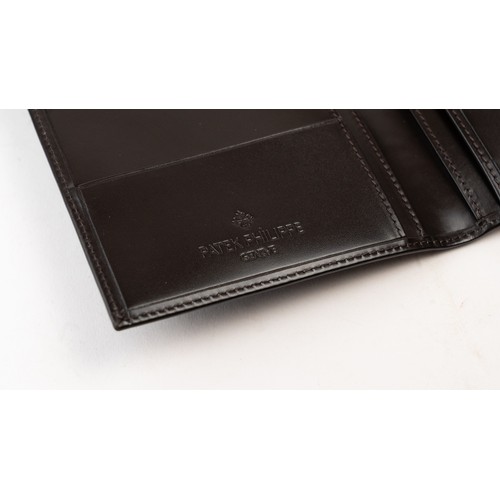 15 - BRAND-NEW DARK BROWN A PATEK PHILIPPE PASSPORT HOLDER, CENEVE
Of rectangular form, crafted in dark b... 