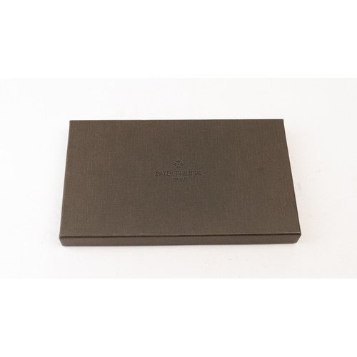 15 - BRAND-NEW DARK BROWN A PATEK PHILIPPE PASSPORT HOLDER, CENEVE
Of rectangular form, crafted in dark b... 