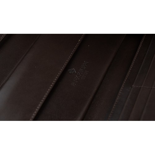 16 - BRAND-NEW DARK BROWN LEATHER PATEK PHILIPPE WALLET, GENEVE
Of rectangular form, crafted in dark brow... 