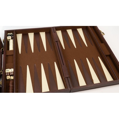 51 - A BRIEFCASE-STYLE BACKGAMMON PLAY,

 Of rectangular form, the suitcase crafted in brown suede with d... 