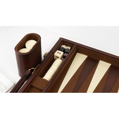 51 - A BRIEFCASE-STYLE BACKGAMMON PLAY,

 Of rectangular form, the suitcase crafted in brown suede with d... 