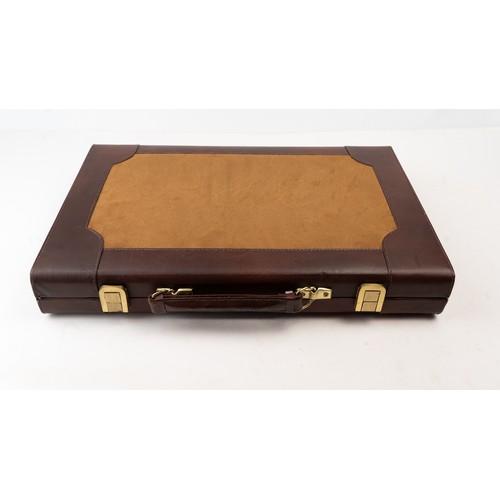 51 - A BRIEFCASE-STYLE BACKGAMMON PLAY,

 Of rectangular form, the suitcase crafted in brown suede with d... 