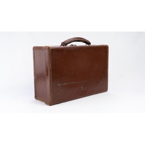 106 - A DARK BROWN LEATHER BRIEFCASE, EARLY 20th CENTURY 
Of rectangular form, a small briefcase featuring... 