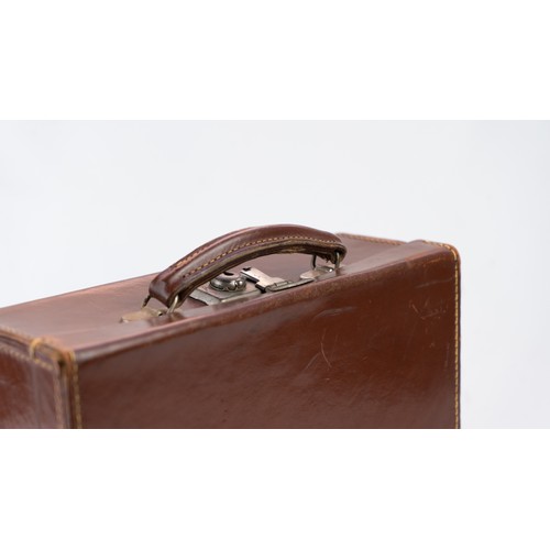 106 - A DARK BROWN LEATHER BRIEFCASE, EARLY 20th CENTURY 
Of rectangular form, a small briefcase featuring... 