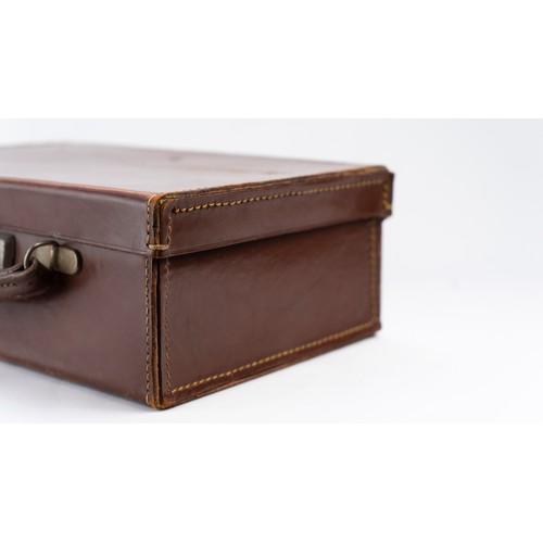 106 - A DARK BROWN LEATHER BRIEFCASE, EARLY 20th CENTURY 
Of rectangular form, a small briefcase featuring... 