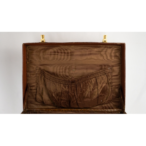 112 - A BROWN CROCODILE SUITCASE
Of rectangular form, fashioned in dark brown crocodile embossed leather, ... 