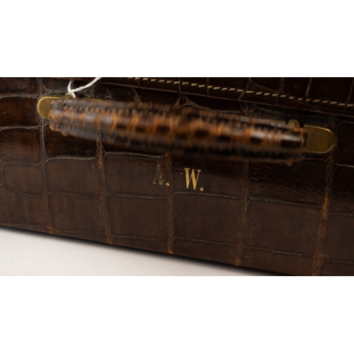 113 - A FINE LEATHER CROCODILE-EMBOSSED TRAVEL CASE, EARLY 20TH CENTURY
Of rectangular form, crafted in ri... 