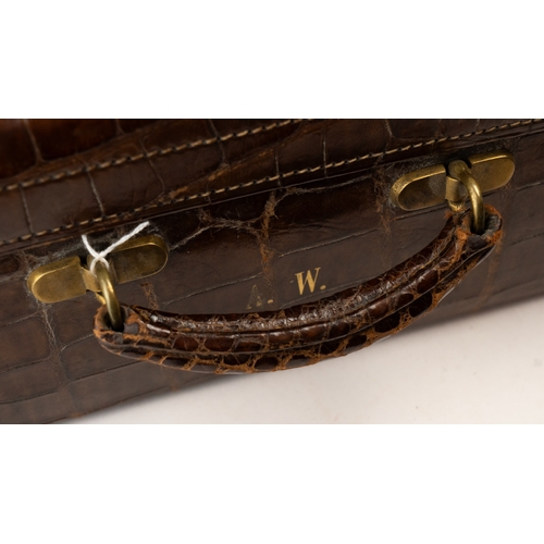 113 - A FINE LEATHER CROCODILE-EMBOSSED TRAVEL CASE, EARLY 20TH CENTURY
Of rectangular form, crafted in ri... 