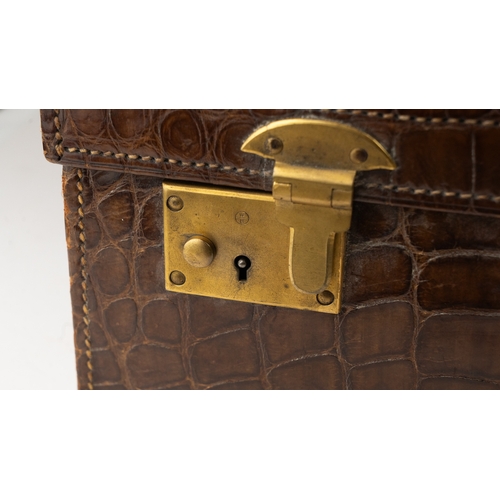 113 - A FINE LEATHER CROCODILE-EMBOSSED TRAVEL CASE, EARLY 20TH CENTURY
Of rectangular form, crafted in ri... 