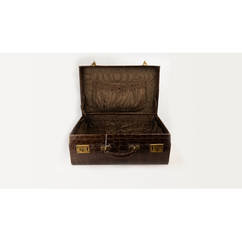 113 - A FINE LEATHER CROCODILE-EMBOSSED TRAVEL CASE, EARLY 20TH CENTURY
Of rectangular form, crafted in ri... 