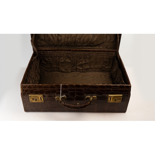 113 - A FINE LEATHER CROCODILE-EMBOSSED TRAVEL CASE, EARLY 20TH CENTURY
Of rectangular form, crafted in ri... 